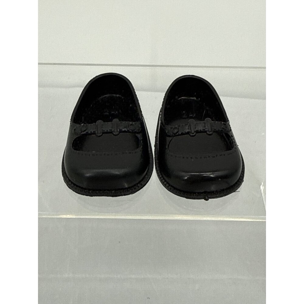 Miniature doll shoes in a classic Mary Jane style